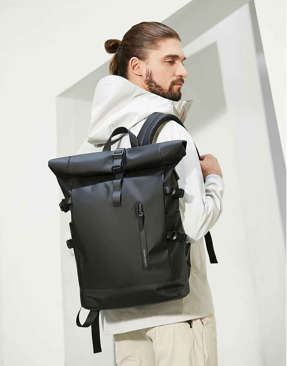 homme portant sac a dos impermeable noir